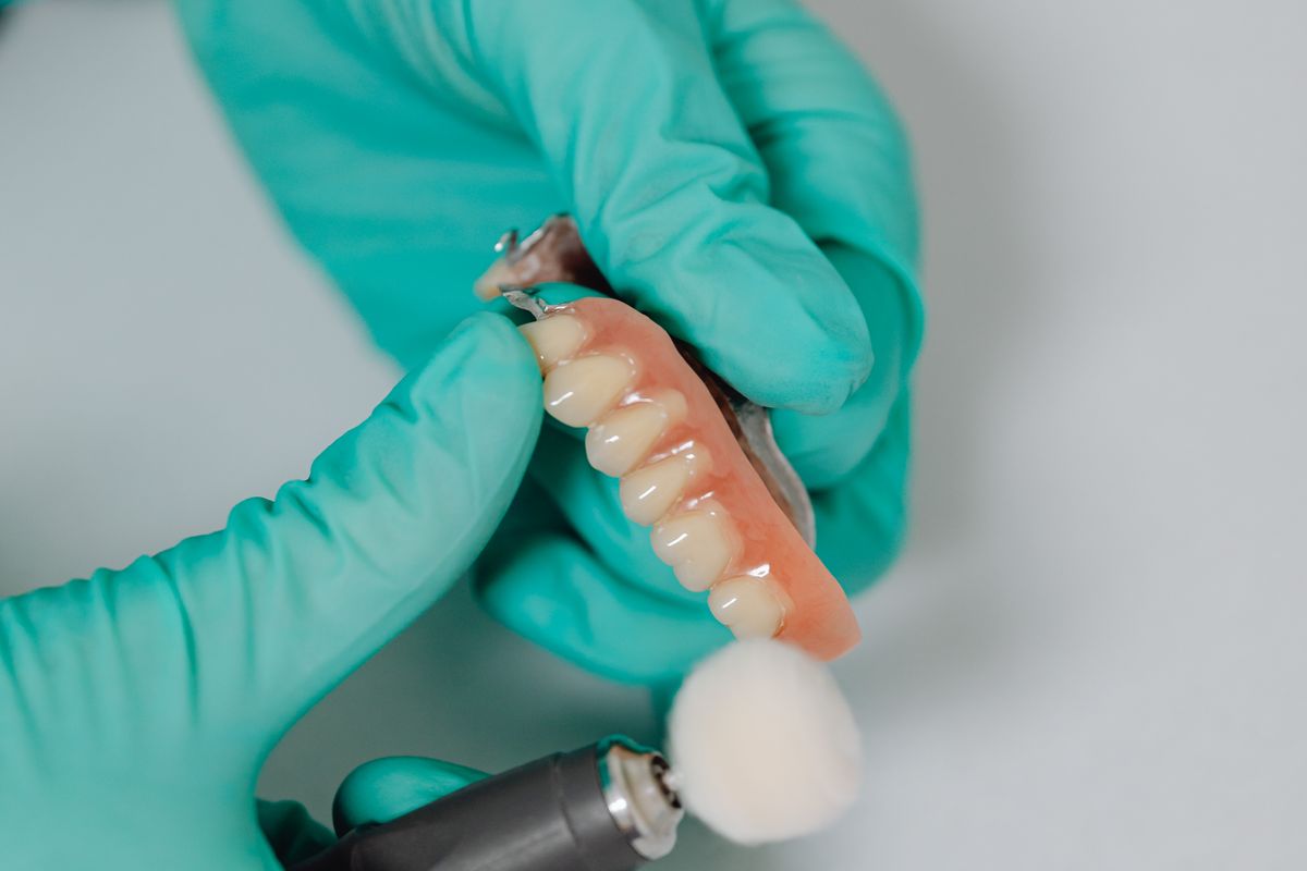 Denture being hand-polished at MARS USA Dental Lab